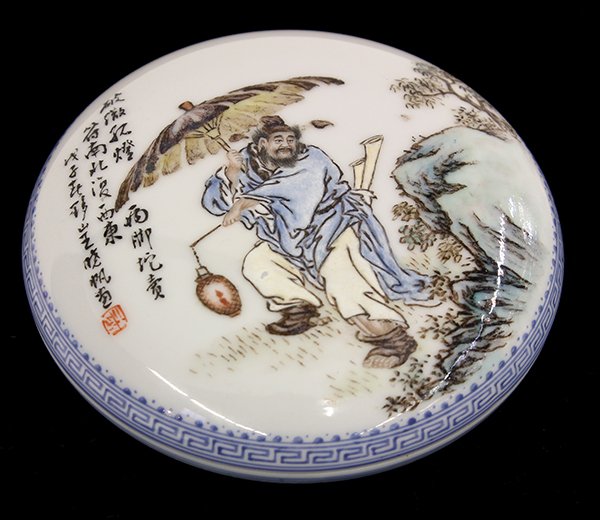 Chinese Enameled Porcelain Circular Covered Container: Chinese enameled porcelain circular covered container, with a figure holding an umbrella and lantern while walking in the rain, bearing colophon and signature 'Wang Xiaofan', base with seal 'Xiaofan',