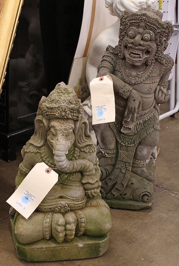 Two Indonesian Figural Sculptures: (lot of 2) Indonesian cast cement sculptures, the first of Ganesha with its trunk in a honey pot; the second of a demon standing on a plinth, 23.5"h