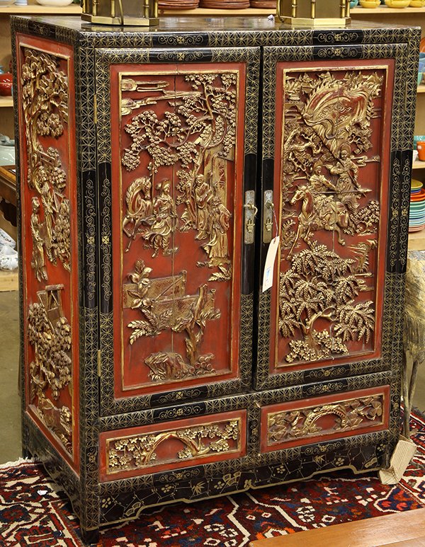 Chinese Gilt Lacquered Cabinet, Figures: Chinese gilt and red lacquered cabinet, the double doors carved with female warriors in landscape within a black frame, 48"h. Provenance: From the estate of Edward Gerber