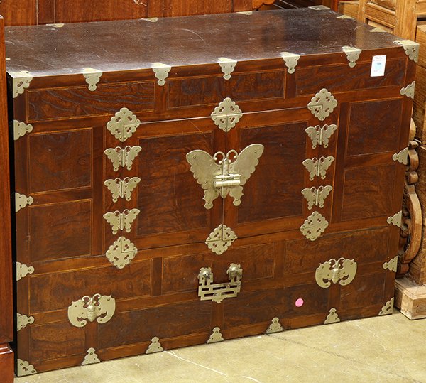 Korean Wood Cabinet: Korean wooden cabinet, fronted by a pair of small double doors with butterfly brass fittings, 25"h x 35"w x 16.25"d. Provenance: From the estate of Edward Gerber