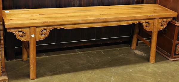 Chinese Long Wood Bench: Chinese wood bench, with a plain apron and ruyi form spandrels framing the circular supports, 66.5"w. Provenance: From the estate of Edward Gerber