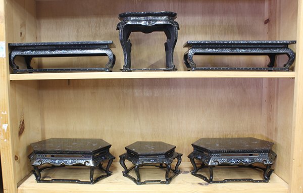 Chinese Lac Burgaute Stands: (lot of 6) Two shelves of Chinese lac burgaute stands, decorated with treasures and tendril patterns executed in mother-of-pearl inlay, largest: 13"w; Provenance: From the estate of Edward Gerber