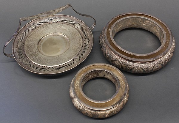 (lot of 2) Silver plate table articles: (lot of 2) Silver plate table articles, consisiting of a Malaysian two tier round epergne having chased decorations depicting of the coats of arms of the Malaysian states, 4"h x 9.5"dia; together with