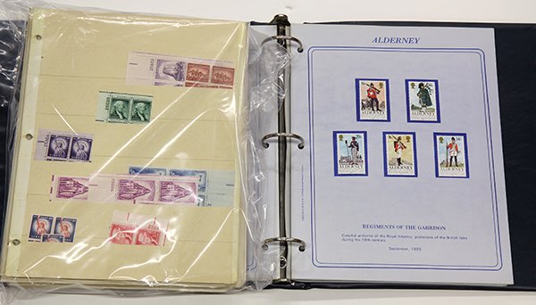 A box lot of U: A box lot of U.S. and world stamps including 24 stock and display sheets of mostly 1950's-70's mint singles and blocks, a commemorative Stamp Society album (1980's) an album of 1960's U.S. plate block