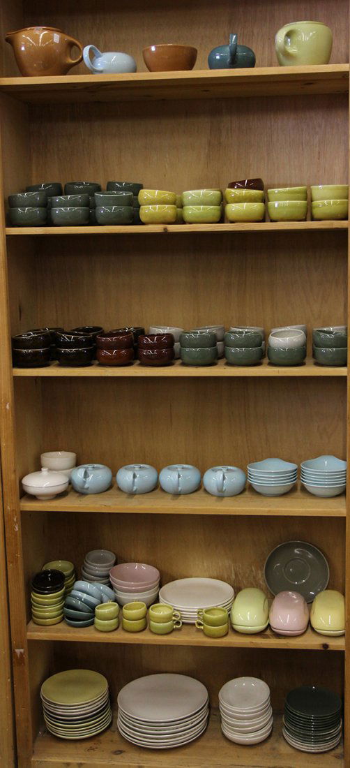 California art pottery: (lot of approx. 187) Six shelves of California art pottery including by Russel Wright, executed in pastel pink, light blue, and various shades of green and brown, consisting of tea cups, dinner, plate