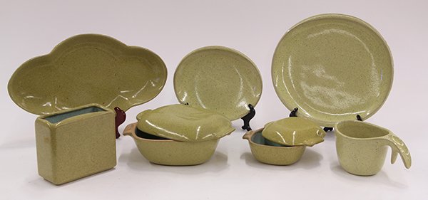 Glidden art pottery tableware: (lot of 21) Glidden art pottery tableware, executed in a mottled yellow, including creamers, sauce boats, lidded tureens, serving trays, etc. largest: 5.5"h
