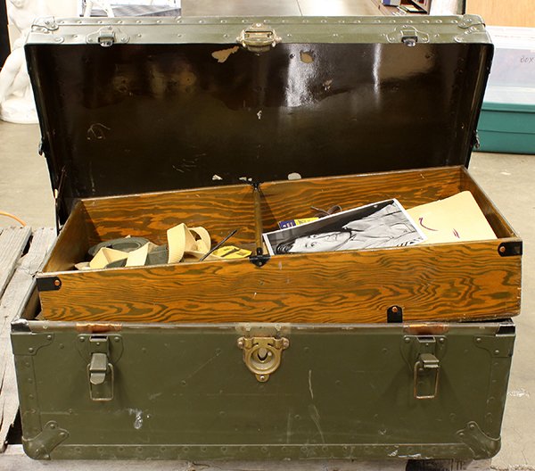 US military trunk with archives and ephemera: US soldier A.E. Gonzales military trunk of archives including flags, newspaper clippings, boot brushes, etc.