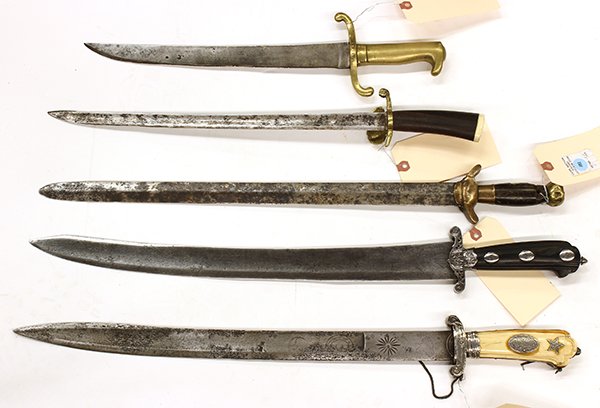 (lot of 5) Continental daggers and short swords: (lot of 5) Continental daggers and short swords, 19th century, consisting of a dagger with a shell guard, rosewood handle and bone cap; an dagger with a brass hilt dated 1869, and a short sword with a