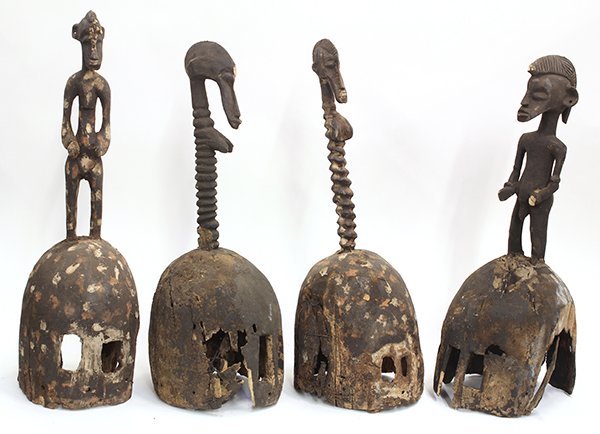 Senufo style, Cote d' Ivoire helmet masks surmounted: (lot of 4) Senufo style, Cote d'Ivoire helmet masks surmounted with stylized male and female figures, 24" (losses). Provenance: From the estate of Edward Gerber