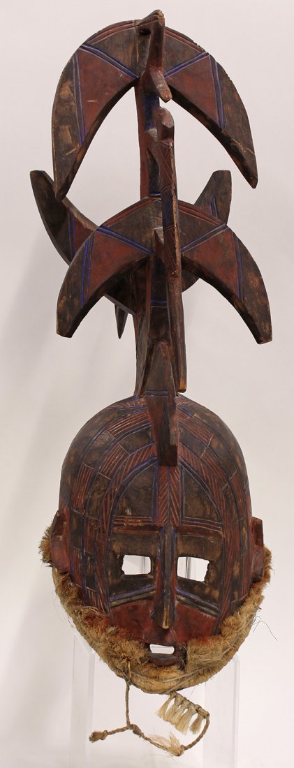 Bobo, Burkina Faso dance mask showing signs of age and: Bobo, Burkina Faso dance mask showing signs of age and use, decorated with red and blue pigments, and surmounted with birds and animals, 26"h. Provenance: From the estate of Edward Gerber
