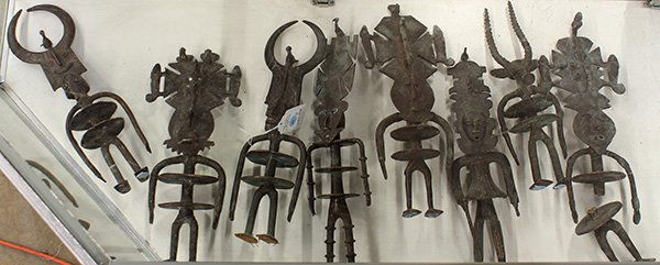 Burkina Faso, Gurunsi style decorative brass figures: (lot of 8) Burkina Faso, Gurunsi style decorative brass figures, 20th century, depicting dancers wearing tall masks, largest: 16"l. Provenance: From the estate of Edward Gerber