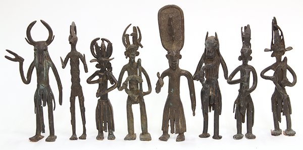 Burkina Faso, decorative brass figures: (lot of 8) Burkina Faso, decorative brass figures, 20th century, each depicted standing and wearing a mask or headpiece, largest: 11"h Provenance: From the estate of Edward Gerber
