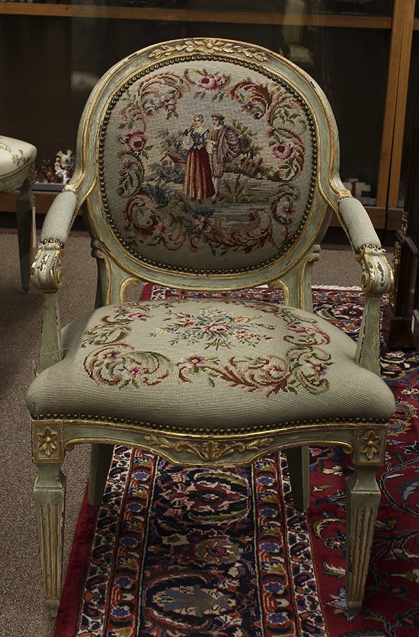 Louis XVI style fauteuil: Louis XVI style fauteuil, 19th century, having a carved floral crest above needlepoint upholstered back, seat, and arms with scrolled terminals, the carved skirt flanked by rosettes above the tapering