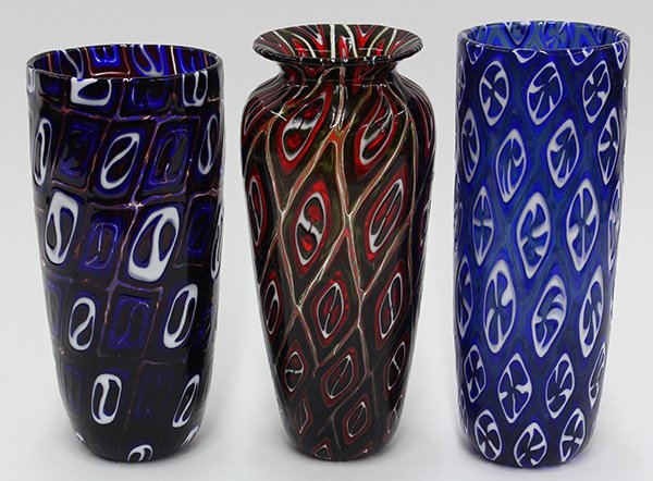 (lot of 3) Art glass vases by Michael Nourot (American: (lot of 3) Art glass vases by Michael Nourot (American b.1949), circa 1980, each vase of cylindrical form, having repeating geometric patterns executed in the Venetian murrini technique, in ruby on ol