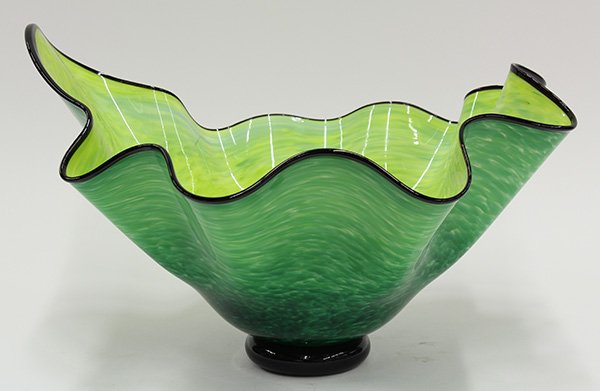 Abstract art glass center bowl: Abstract art glass center bowl, executed in mottled lime and grass green with an applied black ribbon rim and tapering to a circular black foot, signed Chloe '11, 10"h x 15"w x 12.5"d