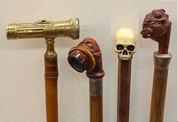 (lot of 4) Walking stick group: (lot of 4) Walking stick group, consisting of a flashlight mounted as a handle with a brass collar above a bamboo stick, ending in a hard wood ferrule, 36"l; (2) pipe sticks having knob handles formed