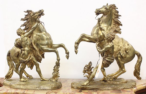 (lot of 2) French bronze figural sculptures depicting: (lot of 2) French bronze figural sculptures depicting the Marly Horses, after Nicholas Coustou, each depicting a rearing stallion, restrained by young partially nude male attendants, and rising on a n
