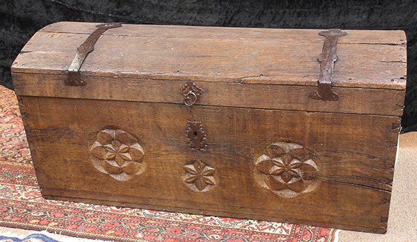 Continental carved bounty chest, late 18th / early 19th: Continental carved bounty chest, late 18th / early 19th century, the domed top with fitted iron hardware, flanked by side handles, the front case decorated with carved rosette medallions, 25"h x 52"w 