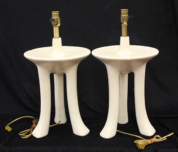 Pair of John Dickinson 'African' table lamps: Pair of John Dickinson 'African' table lamps, circa 1980, executed in painted plaster, having a single socket above a circular surface rising on tripod animal legs, unmarked, 17"h x 11.75" dia