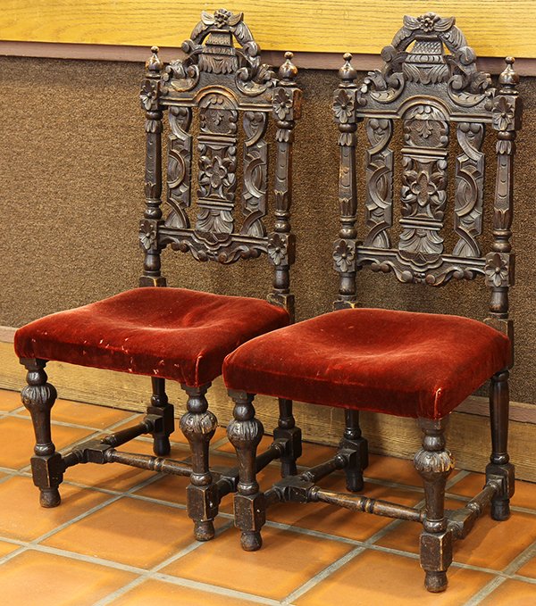 Pair of Renaissance style hall chairs: Pair of Renaissance style hall chairs, last quarter 19th century, the pierced back with geometric and floral reserves continuing to the red velvet seat, and rising on baluster form legs conjoined by t