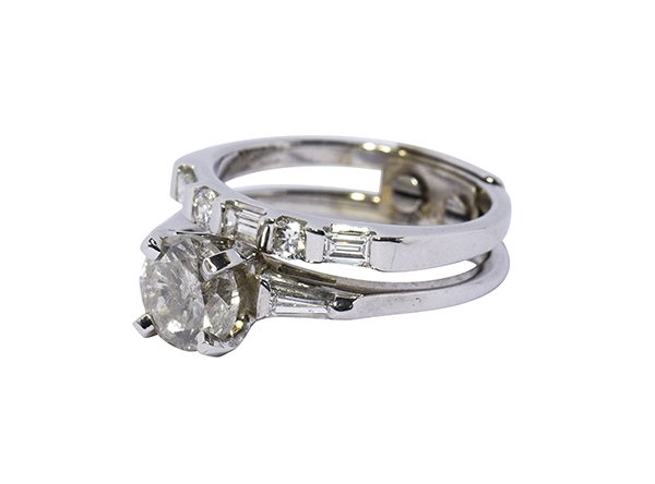 Diamond and 14k white gold wedding ring suite: Diamond and 14k white gold wedding ring suite the engagement ring is center set with one round brilliant cut diamond weighing approximately 1.26 cts., accented by two tapered baguette cut diamonds set
