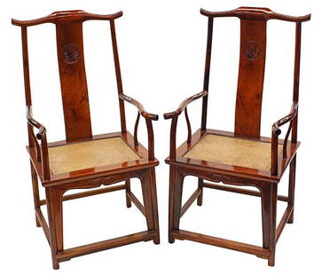 Two Chinese Huanghuali Official's Hat Armchairs: Pair of Chinese huanghuali hardwood official's hat armchairs (guan mao yi), with the characteristic top rail suspending a narrow back splat carved with a peony medallion, having a pair of curvilinear