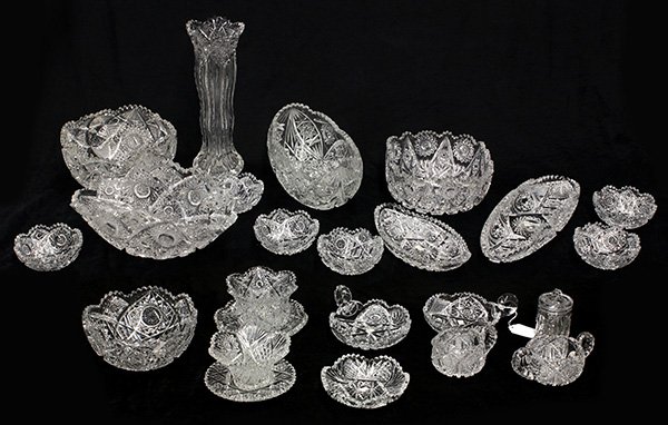 Group of crystal table articles: (lot of 22) Group of crystal table articles, each having a scalloped border and having hobstar and repeating geometric decoration, consisting of (6) nappies, (4) serving bowls, two long trays, largest