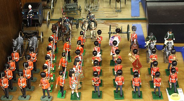 Collection of painted lead toy soldiers: (lot of 48) Collection of painted lead toy soldiers, mostly British, in various poses including standing with swords, musical instruments, riding horseback, etc.; together with a carriage with two hor