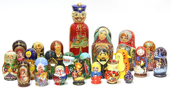 Russian style nesting dolls: (Lot of 23) Russian style nesting dolls, some depicting Santa Claus, others Madonna and Child, some of women others of men, in various sizes, 9"h