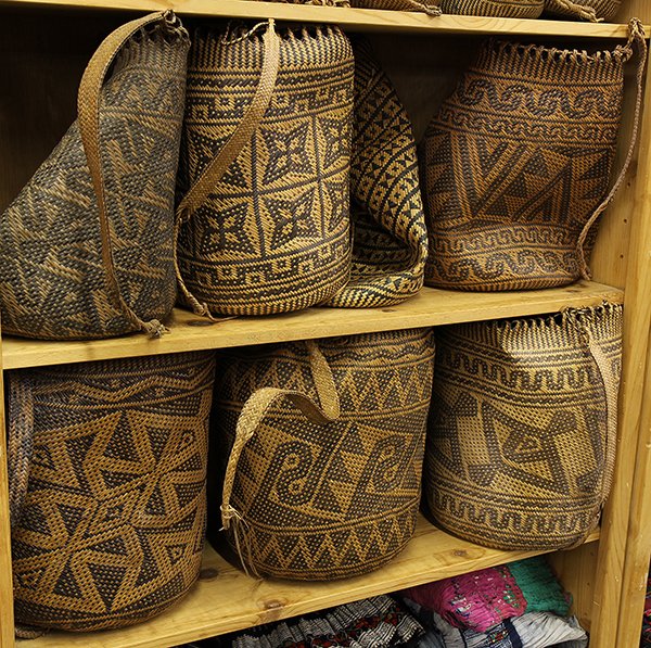Group of large ethnographic woven baskets: (lot of 7) Group of large ethnographic woven baskets, each decorated geometric reserves, and having a long strap, largest: 13.5"h. Provenance: From the estate of Edward Gerber