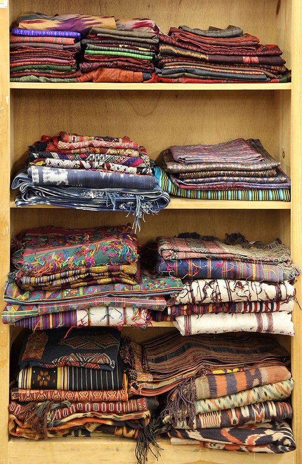 Four shelves of Indonesian textiles: (lot of 83) Four shelves of Indonesian textiles, probably from Java, Sumatra, Flores, Timor, etc., each having mutli-color abstract geometric patterns, in various sizes. Provenance: From the estate of