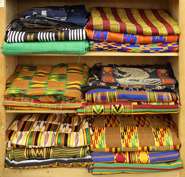 Collection of mostly African textiles: (lot of 20) Collection of mostly African textiles executed in bright yellow, red, and orange, having repeating geometric patterns. Provenance: From the estate of Edward Gerber