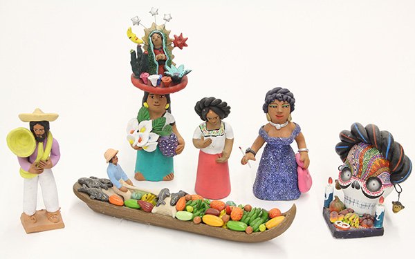 (lot of 29) One shelf of Mexican pottery figures,: (lot of 29) One shelf of Mexican pottery figures, depicting everyday life, religious figures, and Day of the Dead skulls, tallest 9.5"h