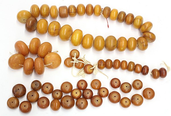 Amber resin/copal trade beads: (lot of 4) Amber resin/coral trade beads, including one necklace, a bracelet, an unfinished necklace, and grouping of loose beads, necklace: 16.5"l. Provenance: From the estate of Edward Gerber