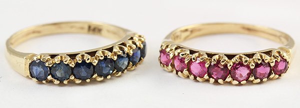 Ruby, sapphire and 14k yellow gold stacking rings: (Lot of 2) Ruby, sapphire and 14k yellow gold stacking rings including a 14k yellow gold band mounting set with seven round cut rubies totaling approximately 0.85 ct., together with a matching 14k yel