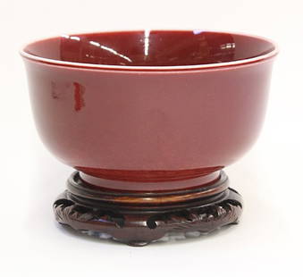 Chinese Ox-blood Bowl: Chinese ox-blood glazed porcelain bowl, the deep bowl with a slightly flared rim, raised on a foot ring, with wood stand, bowl: 8"w