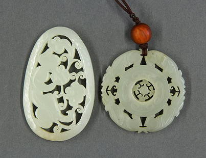 Two Chinese Jade Plaques: (lot of 2) Chinese small jade plaques, the first pierced with zoomorphs encircling a movable center; the second, with a meandering chilong and scrolling sprigs, 3"w