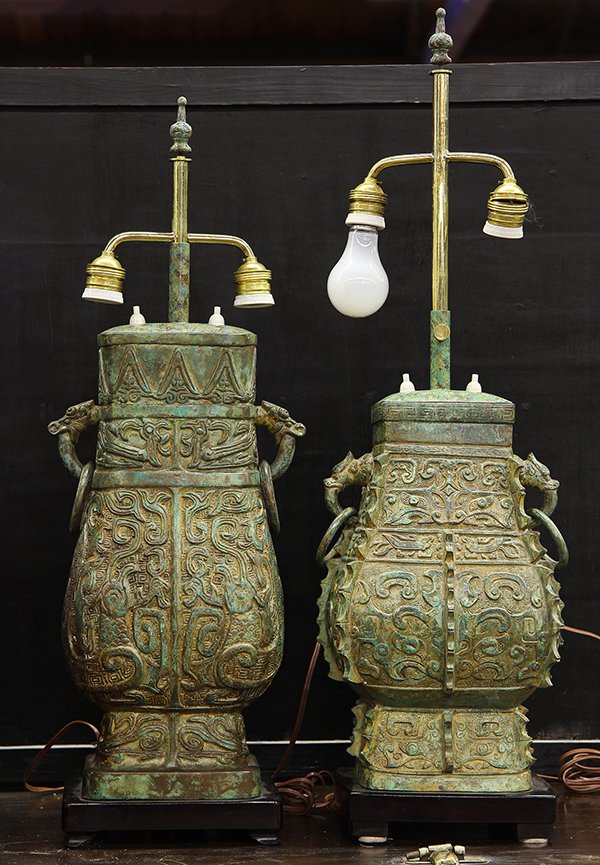 Three Chinese Archaistic Vessels: (lot of 3) Chinese archaistic metal vessels, now mounted as lamps, each of hu form cast with taotie or archaistic zoomorphs, 32.25"h. Provenance: From the estate of Edward Gerber