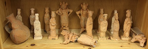 One Shelf of Chinese Pottery Figures/ Vessels: (lot of 18) One shelf of Chinese pottery figures/vessels, figures including guardians, court ladies and attendants, largest: 9"h. Provenance: From the estate of Edward Gerber