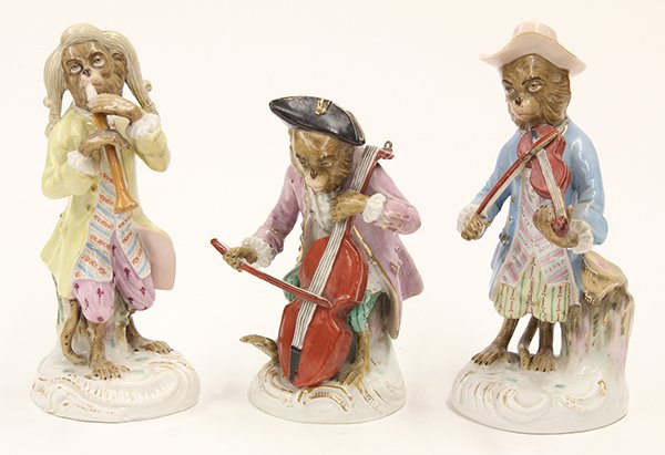(lot of 3) Continental porcelain monkey orchestra: (lot of 3) Continental porcelain monkey orchestra members in the style of Meissen, 19th century, consisting of a cello player, violin player, and flutist, each depicted in colorful 18th century attire