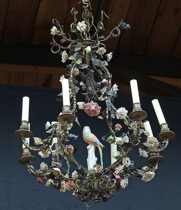 Continental 'Basket' chandelier: Continental 'Basket' chandelier, 19th century, executed in tole with eight curved arms flanking the shaped standard centered by a porcelain parrot on a perch, the whole heavily festooned with applied