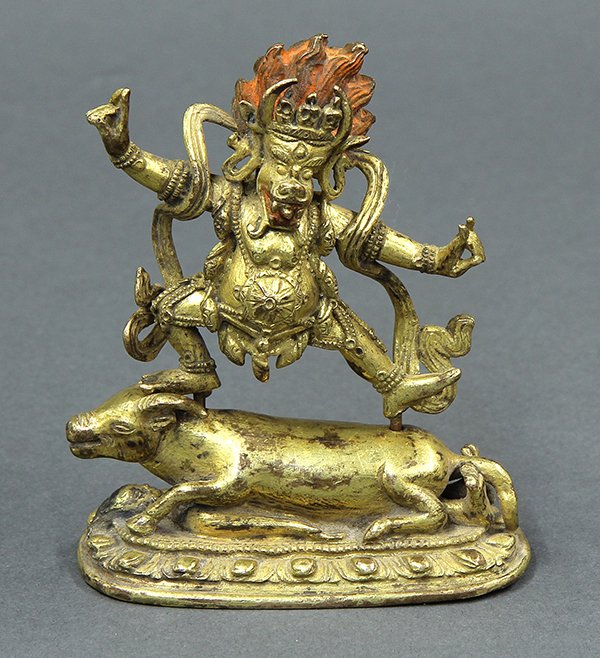 Sino-tibetan Bronze Yamantaka: Sino-Tibetan gilt bronze Buddhist deity, of Yamantaka with red pigment accenting hair and mouth, standing on a recumbent bull, 3.75"h