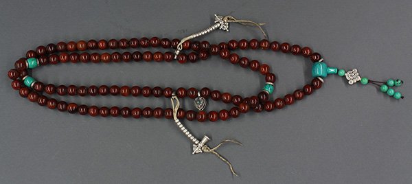 Horn Prayer Beads: Sino-Tibetan horn Buddhist prayer beads, comprising 108 spherical beads, attached with metallic religious emblems and turquoise colored beads, overall: 66"