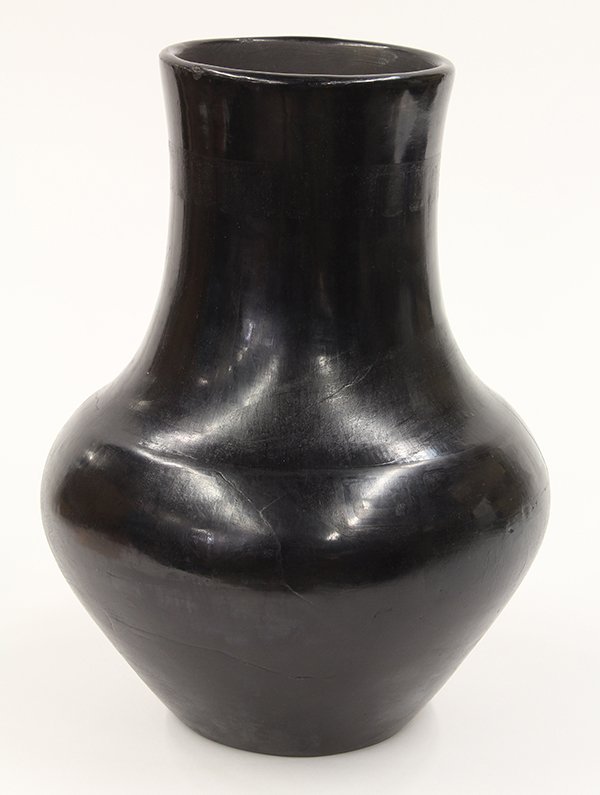 San Ildefonso blackware vessel by Maria and Julian: San Ildefonso blackware vessel by Maria and Julian (Martinez), circa 1935, having a long neck above a bulbous body, the neck with a band of feather decoration, signed Marie Julian; 11.5"h x 7"dia (dam
