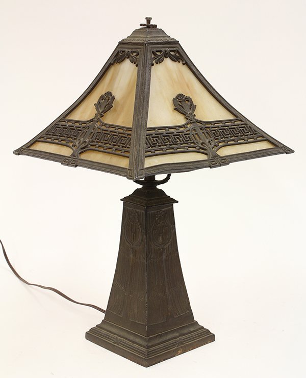 Arts and Crafts slag glass table lamp: Arts and Crafts slag glass table lamp, having a paneled shade with patinated metal overlay rising on an obelisk form standard resting on a square base; 18"h x 10.5"sq