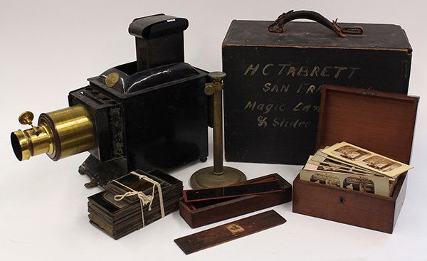 (lot of approximately 36) Magic Lantern projector: (lot of approximately 36) Magic Lantern projector group, consisting of a projector made by W. Farcher, Liverpool, (approx 19) glass slides, mostly depicting European landmarks and Roman ruins, a woode