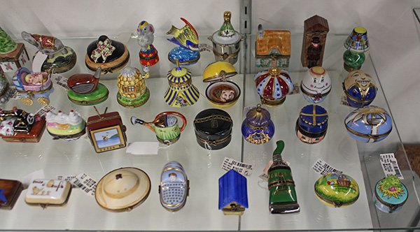 (lot of approximately 51) Large collection of mostly: (lot of approximately 51) Large collection of mostly Limoges polychrome painted porcelain pill boxes, in various shapes including eggs, cakes, golf club, champagne bucket, etc., largest: 4.5"h