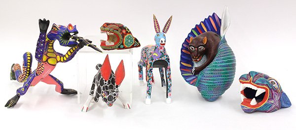 (lot of approximately 18) Two shelves of Oaxacan: (lot of approximately 18) Two shelves of Oaxacan Alebrijes, executed in polychrome carved wood, including chimeras, dragons, rabbits, vampire bats, Noah's Ark, and leopard heads, by artists such as Ze