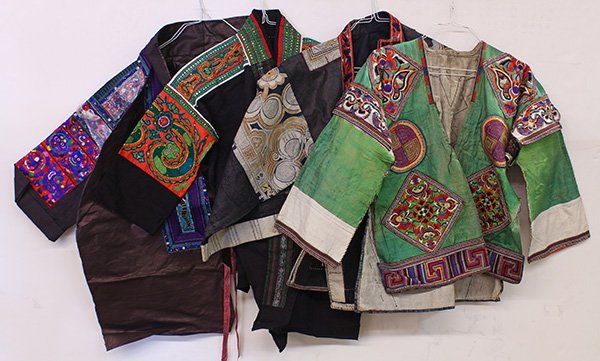 Southeast Asian traditional textiles hand-stitched into: (lot of 4) Southeast Asian/Chinese hill tribe traditional textiles hand-stitched into embroidered garments; Provenance: From the estate of Edward Gerber