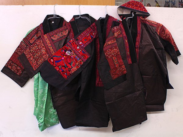 Southeast Asian traditional textiles hand-stitched into: (lot of 4) Southeast Asian/Chinese hill tribe traditional textiles hand-stitched into embroidered garments, and matching hat; Provenance: From the estate of Edward Gerber